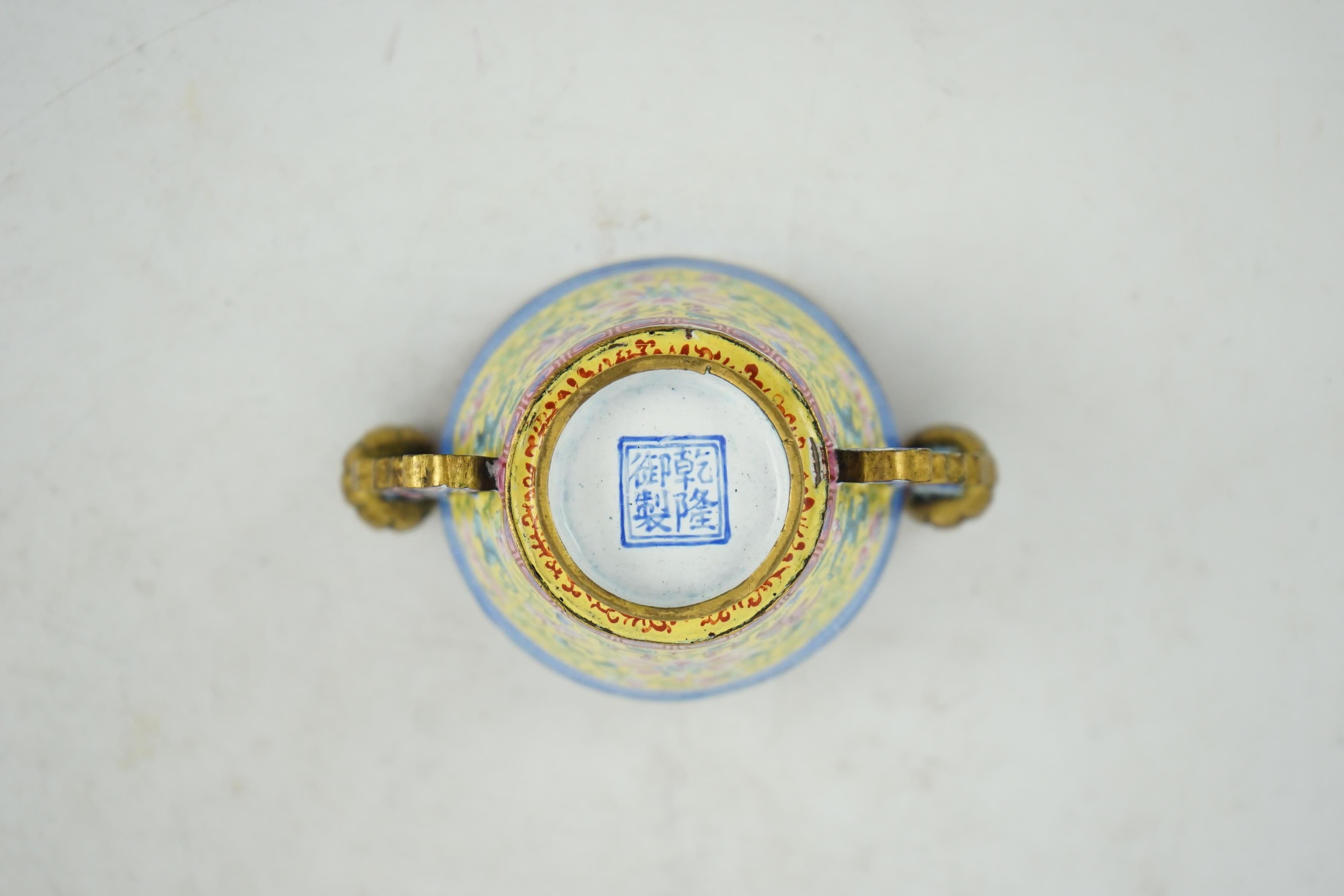 A Chinese Guangzhou enamel two handled wine cup, four character Qianlong mark and of the period (1736-1795)